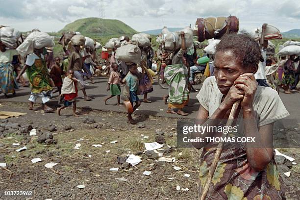 Picture dated 15 November 1996 of an old woman resting along the road where hundred of thousands of Rwandan refugees were on their way to cross the...