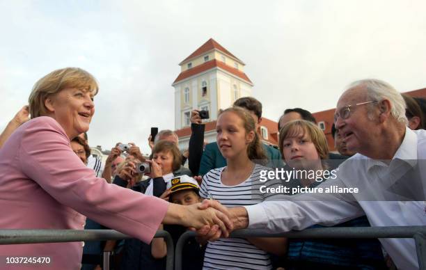 German Chancellor Angela Merkel meets tourists and citizens on a walkabout during an election campaign event in Binz on Ruegen, Germany, 22 July...