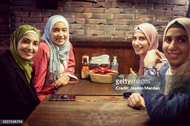 group of arab girls together - arab family in hotel stock-fotos und bilder