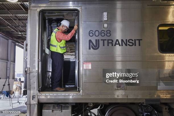 Worker stands in the doorway of a New Jersey Transit train car in Piscataway, New Jersey, U.S., on Thursday, Sept. 20, 2018. NJ Transit has struggled...