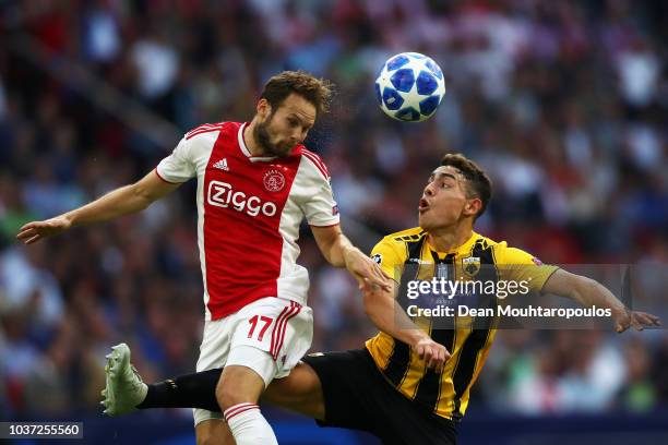 Daley Blind of Ajax battles for the ball with Viktor Klonaridis of AEK Athens during the Group E match of the UEFA Champions League between Ajax and...