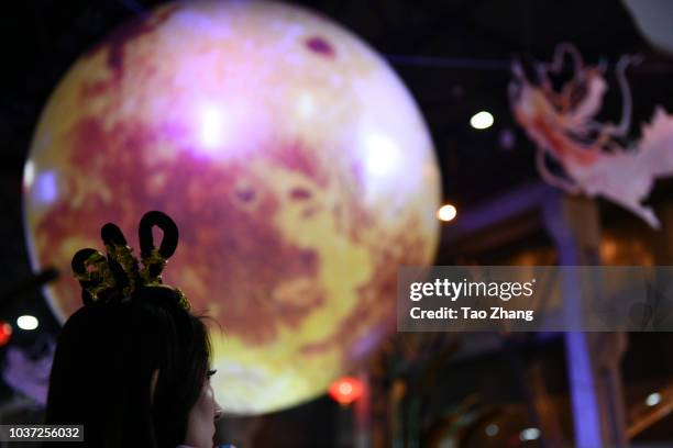 Woman dress traditonal costume as Chang'e in front of Lantern to mark the upcoming Mid-Autumn Festival September 21, 2018 in Harbin, China. As one of...