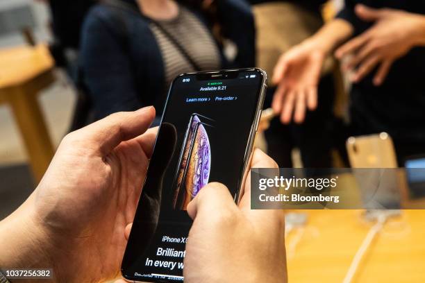 Customer views an Apple Inc. IPhone XS during a sales launch at a store in New York, U.S., on Friday, Sep. 21, 2018. The iPhone XS is up to $200 more...