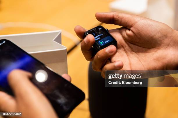 Customer views an Apple Watch Series 4 smartwatch during a sales launch at an Apple Inc. Store in New York, U.S., on Friday, Sep. 21, 2018. The...