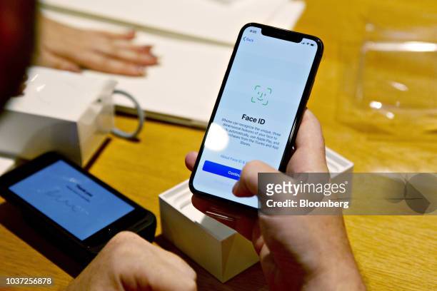 Customer sets up Face ID on an Apple Inc. IPhone XS during a sales launch at a store in Chicago, Illinois, U.S., on Friday, Sept. 21, 2018. The...
