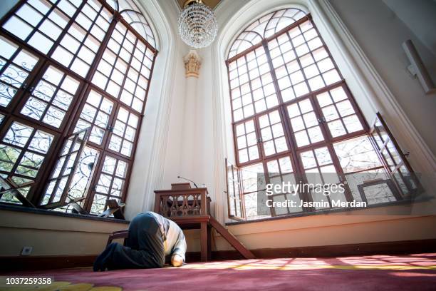 Senior man praying in mosque