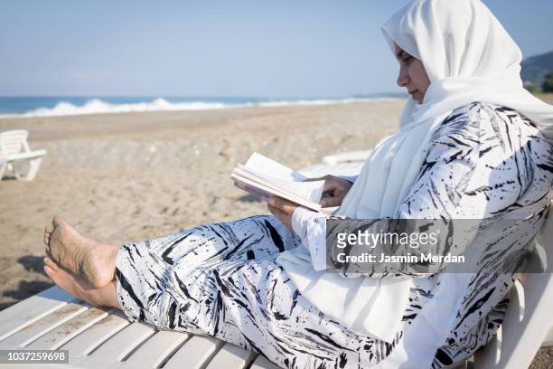 Muslim woman relaxing on beach