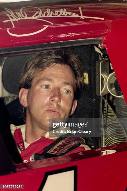 John Andretti sits in his race car before the Pepsi 400 NASCAR Winston Cup race at Daytona International Speedway on July 2, 1994 in Daytona Beach,...