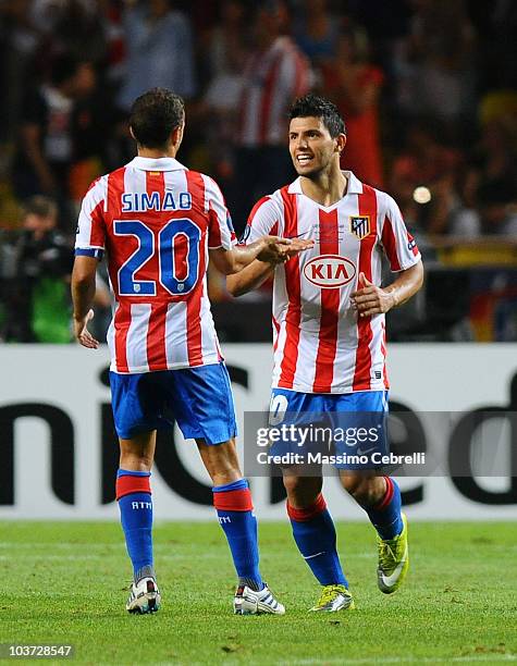 Sergio Aguero of Atletico de Madrid celebrates scoring his team's second goal with team mate Simao during the UEFA Super Cup match between FC Inter...