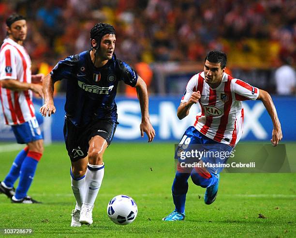 Cristian Chivu of FC Inter Milan battles for the ball against Jose Antonio Reyes of Atletico de Madrid during the UEFA Super Cup match between FC...