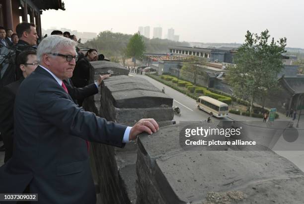 German Foreign Minister Frank-Walter Steinmeier visits a reconstructed gate of the former town hall of Zhengding, China, 13 April 2014. Steinmeier...