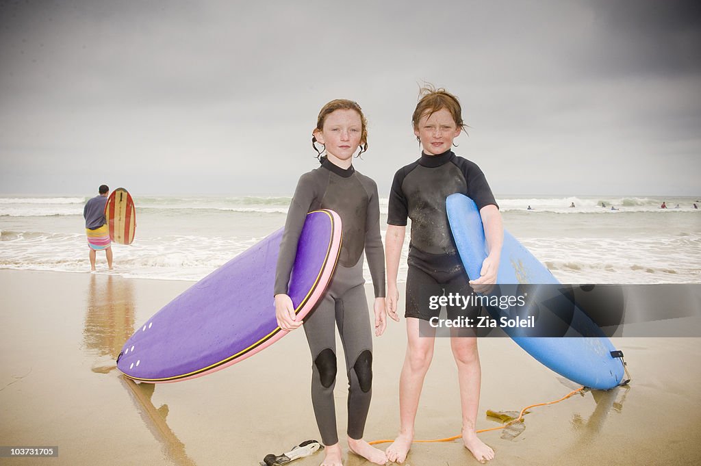 Brother and sister with their surfboards