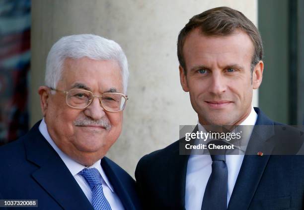 French President Emmanuel Macron welcomes Palestinian President Mahmoud Abbas prior to their meeting at the Elysee Presidential Palace on September...