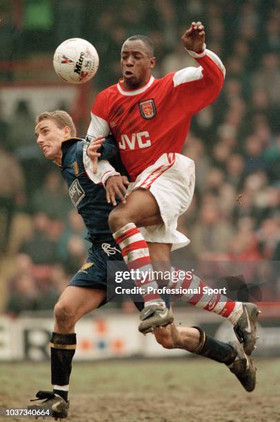 Ian Wright of Arsenal battles with Chris Perry of Wimbledon during an FA Carling Premiership match at Selhurst Park on March 16, 1996 in London,...