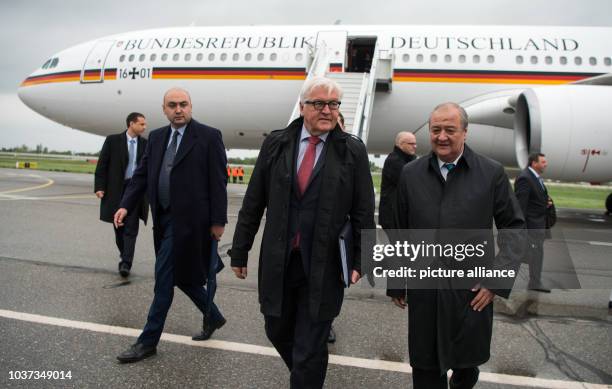 German Minister of Foreign Affairs Frank-Walter Steinmeier is greeted by Abdulaziz Komilov , Uzbek Minister of Foreign Affairs, at the airport in...