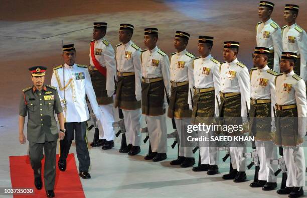Malaysia's King Sultan Mizan Zainal Abidin walks back after inspecting a guard-of-honour during the National Day celebrations in the Bukit Jalil's...