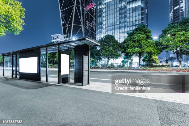 bus stop with illuminated blank billboard - billboards 2017 stock pictures, royalty-free photos & images