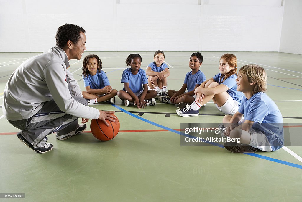 Children with coach in gymnasium