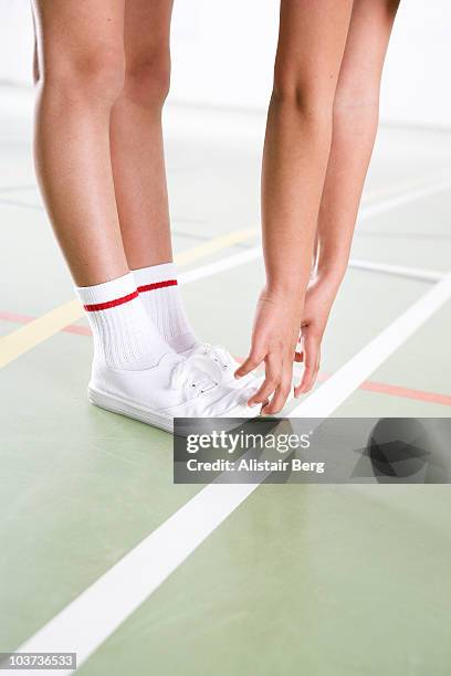 child exercising in gymnasium - leg stretch girl stock-fotos und bilder