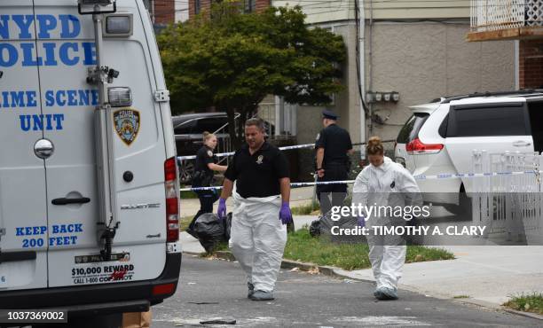 New York Police Department Crime Scene Unit walk out of a daycare center, Mei Xin Care Incorporated located at the owners home in the Flushing area...
