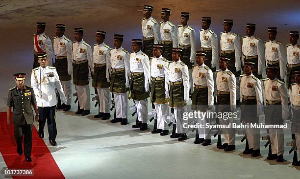 Malaysian King Sultan Mizan Zainal Abidin , walks after he inspects a guard of honor during the National Day celebrations, marking the 53rd...