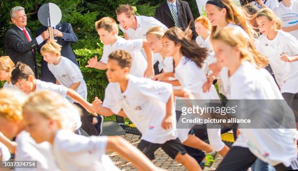German President Joachim Gauck and IOC President Thomas Bach give the starting clap for the garden race during the closing of the sports badge tour...
