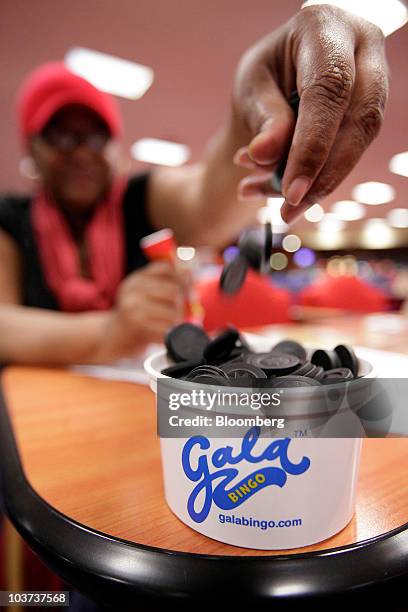 Customer plays with bingo markers at a Gala Bingo club, operated by Gala Coral Group Ltd., in London, U.K., on Thursday, Aug. 26, 2010. Gala Coral...