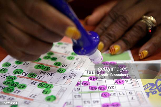 Player marks her bingo card during a game at a Gala Bingo club, operated by Gala Coral Group Ltd., in London, U.K., on Thursday, Aug. 26, 2010. Gala...
