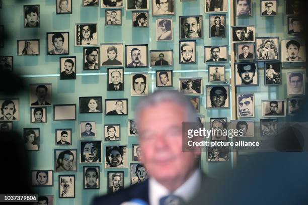German president Joachim Gauck visits the museum of memory and human rights and makes a statement in front of photos of missing persons during the...