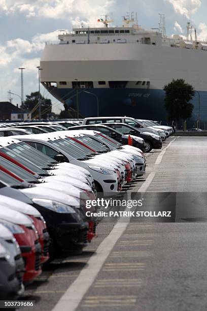 Hyundai cars, covered with protective canvas, are ready to be loaded onto cargo ships at the harbour of Bremerhaven, northern Germany on August 31,...