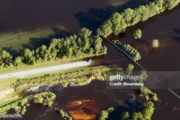 Resident stands on a flooded street in this aerial photograph taken above New Bern, North Carolina, U.S., on Friday, Sept. 21, 2018. Record floods...