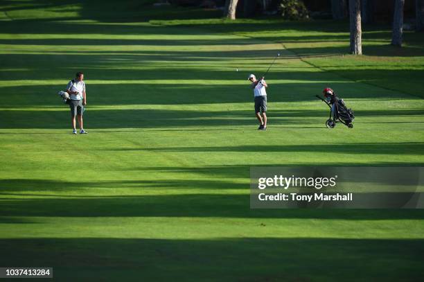 Andrew Robinson of Southwold Golf Club watches James Smith of Southwold Golf Club plays his second shot on the 1st fairway during Day Two of The...