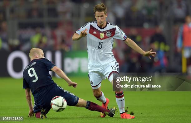 Germany's Erik Durm and Scotland's Steven Naismith vie for the ball during the UEFA EURO 2016 qualifying group D soccer match between Germany and...