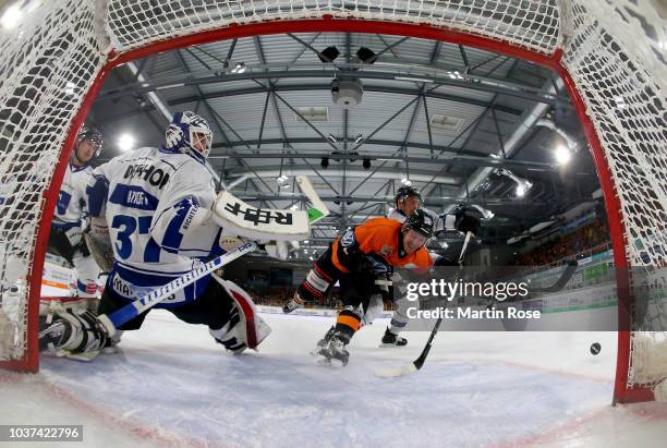 Marcel Ohmann of Wolfsburg fails to score over Jeff Zatkoff, goaltender of Straubing during the DEL match between Grizzlys Wolfsburg and Straubing...