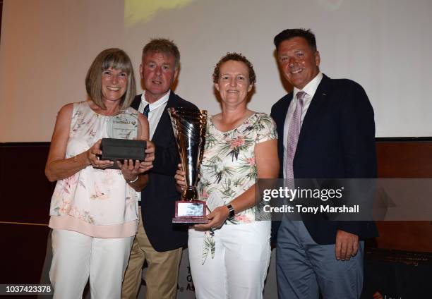 Ian Issac , MD of Lombard and Paul Robinson of Coca Cola pose with the winners of the WPGA Lombard Trophy Grand Final Pat Johnson and Ali Gray of...