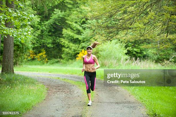 caucasian woman running on remote path - bainbridge island wa stock pictures, royalty-free photos & images