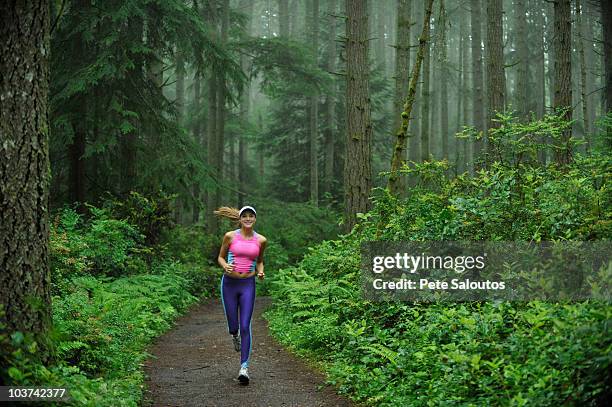 caucasian woman running on remote path - kitsap county washington state stock pictures, royalty-free photos & images