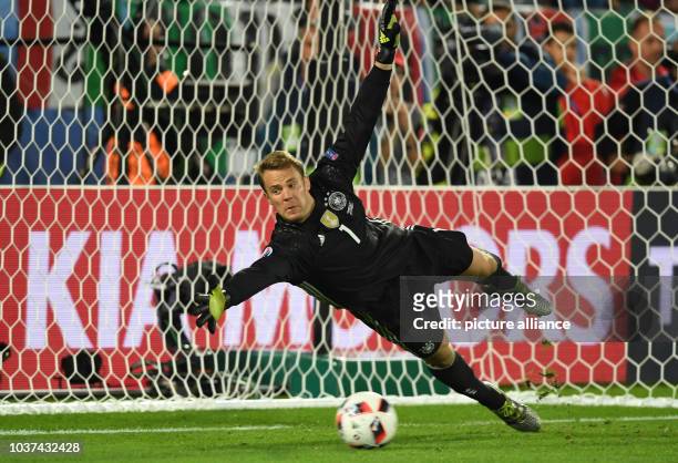 Germany's goalkeeper Manuel Neuer jumpes for the ball during the penalty shoot-out during the UEFA EURO 2016 quarter final soccer match between...
