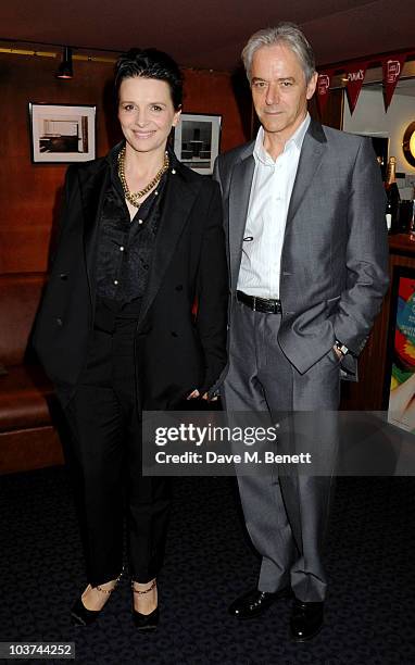 Juliette Binoche and William Shimell pose for a photograph after holding a Q&A session following the screening of 'Certified Copy' at the The Curzon...