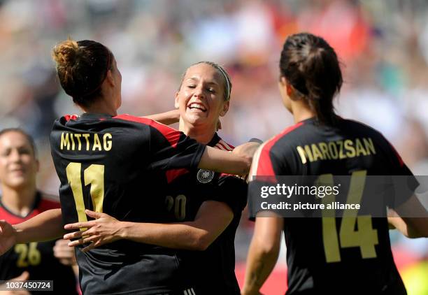 Germany's Lena Goessling celebrates her 1-0 goal with Anja Mittag and Dzsenifer Marozsan during the internationals women's soccer match between...