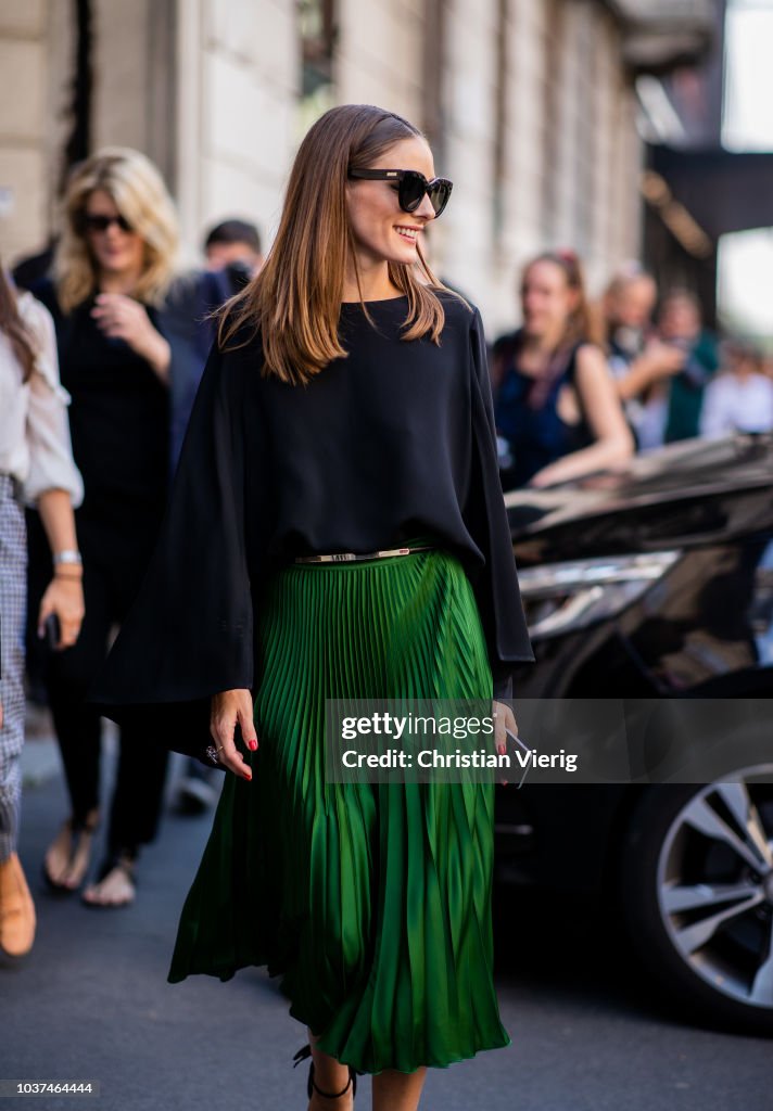 Olivia Palermo wearing green skirt, black cape, heeled sandals seen ...