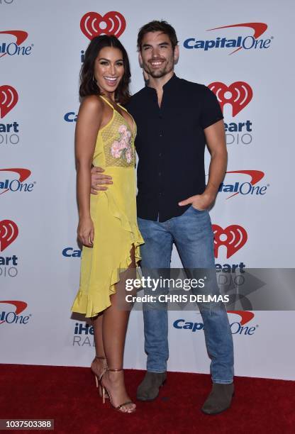 Bachelor in Paradise contestants Ashley Iaconetti and fiance Jared Haibon arrive in the press room for the iHeartRadio Music Festival in Las Vegas,...