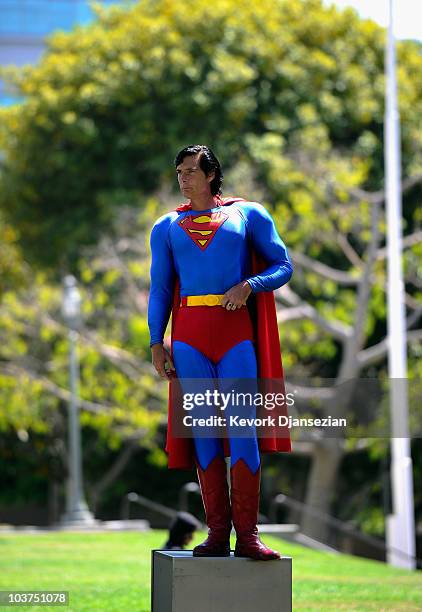 Christopher Dennis, wearing a Superman super hero costume, poses for a Craigs List TV cameraman during a protest with fellow costumed characters at...