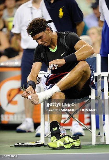 Spanish tennis player Rafael Nadal changes feet bandages during his match against Russia's Teymuraz Gabashvili, during their first round match at the...