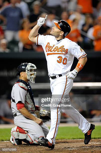 Luke Scott of the Baltimore Orioles celebrates after hitting a home run in the eighth inning against the Boston Red Sox at Camden Yards on August 31,...