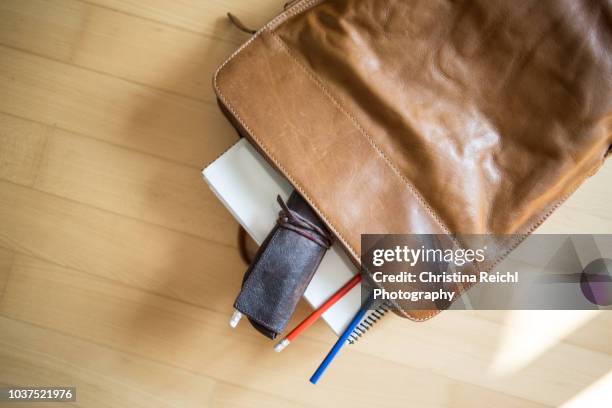 leather rucksack with paper and pencils - etui stockfoto's en -beelden