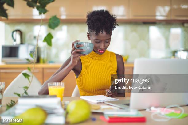 young woman is drinking and making a budget - the 2017 budget preparation stock pictures, royalty-free photos & images