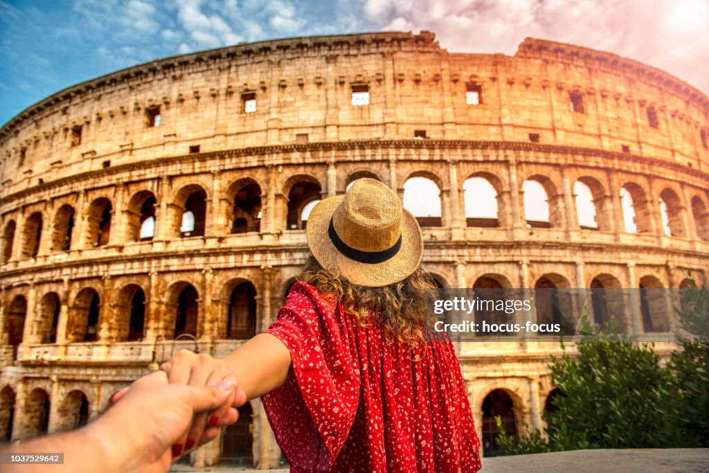 Couple of tourist on vacation in front of Colosseum Rome Italy