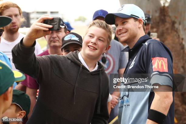 Steve Smith poses for photos with fans during the NSW First Grade Club Cricket match between Sutherland and Mosman at Glenn McGrath Oval on September...