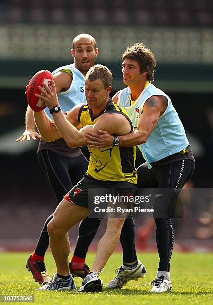 Ryan O'Keefe, Jarrad McVeigh and Brett Kirk of the Swans fight for the ball during a Sydney Swans AFL training session at Sydney Cricket Ground on...